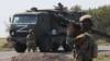 Фото російського інформагенства ТАСС. Російські військовослужбовці супроводжують переміщення військової колонни на окупованій території Запорізької області України 