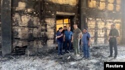 Глава Дагестана Сергей Меликов в сгоревшей в результате нападения синагоге в Дербенте. 24 июня 2024 года