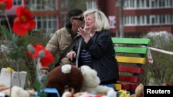 A woman reacts at the site of a deadly Russian missile strike on a residential area in Kryviy Rih that killed several children and adults on April 4.