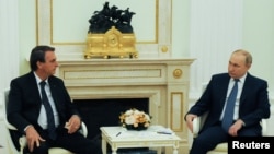 Russian President Vladimir Putin (right) meets with his Brazilian counterpart, Jair Bolsonaro, in Moscow on February 16. 