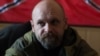 Алексей Мозговой на фоне флага "Новороссии". Октябрь 2014 года