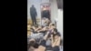 Кадр из видео об избиении мигрантов в московской бане.