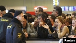 Policija pokušati da se smiri uznemirene putnike na praznim šalterima na aerodromu Domodjedovo, Moskva, 28. decembar 2010.