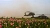 U.S. Special Operations service members with Special Operations Task Force South board two UH-60 Black Hawk helicopters following a clearing operation in Panjwa'i district in the southern province of Kandahar.