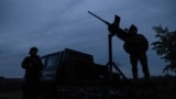 FILE PHOTO: Members of a mobile air defence volunteer unit stand next to their machine gun during the most massive Russian drone attack in Kyiv region