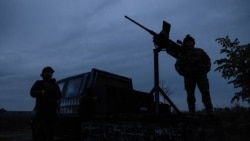 FILE PHOTO: Members of a mobile air defence volunteer unit stand next to their machine gun during the most massive Russian drone attack in Kyiv region