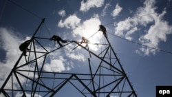 Afghanistan -- Afghan electricity workers set up electricity poles in the Padkhab district of the Logar province, February 20, 2015