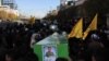 FILE: The burial procession of an Afghan fighter in Iran after he was killed in Syria.