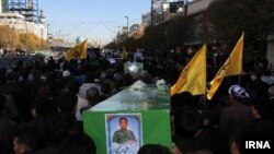 FILE: The burial procession of an Afghan fighter in Iran after he was killed in Syria.