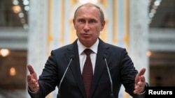Russian President Vladimir Putin gestures as he speaks to the media after talks with Ukrainian President in Minsk on August 27.