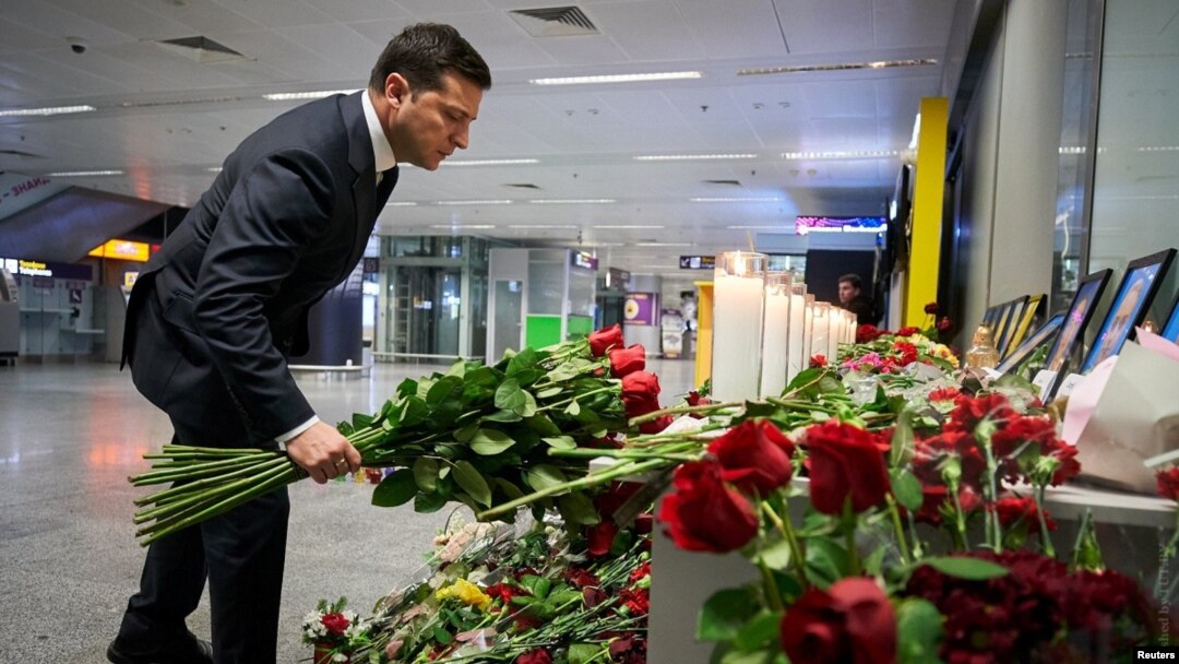 Ukrainian President Volodymyr Zelenskiy lays flowers at a memorial to the crash victims at Kyiv's Boryspil International Airport. 