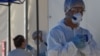 Kazakhstan - Medical specialists wearing protective equipment work at the coronavirus disease (COVID-19) testing facility in Almaty, Kazakhstan July 8, 2020. REUTERS/Mariya Gordeyeva