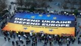 Aktiwistler Brýusselde geçiriljek sammitiň öňüsyrasynda, Ýewropa Geňeşiniň binasynyň daşynda Ukrainany goldamak üçin uly baýdak açýarlar. 5-nji mart, 2025 ý.