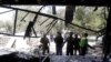 FILE: Afghan security forces inspect the site of a suicide bomb attack in Kabul on August 29.
