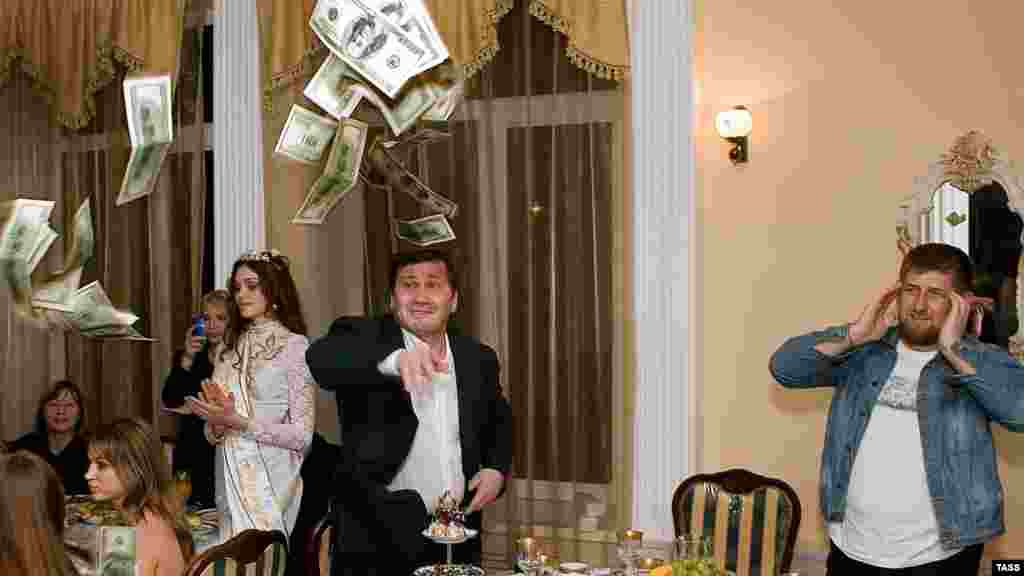Kadyrov (right) watches as a man tosses $100 bills at a restaurant in Gudermes during a celebration to honor the winner of the republic's first "Beauty of Chechnya" pageant in 2006.
