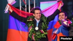 Armenia - Grandmasters Levon Aronian (L) and Gabriel Sargsian celebrate their team's victory in the 2012 World Chess Olympiad in Yerevan's Liberty Square, 10Sep2012.