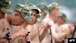 Russian soldiers clean their rifles at the military base in Tskhinvali.